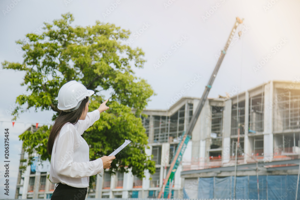 A female engineer holds a file and points out. A female engineer holds a file and points out.