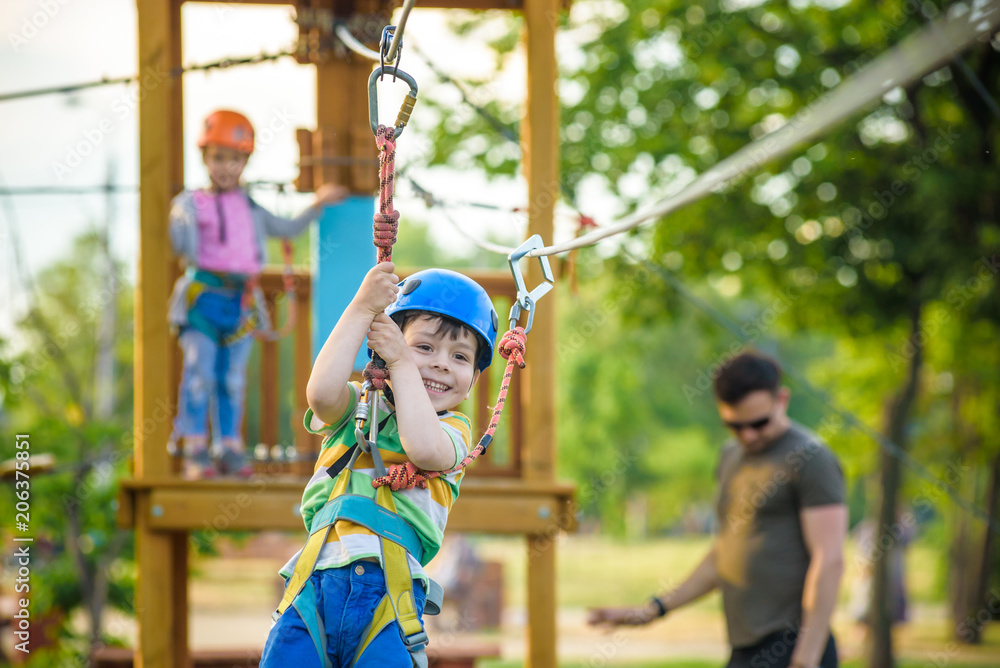 Obraz premium Young boy playing and having fun doing activities outdoors. Happiness and happy childhood concept