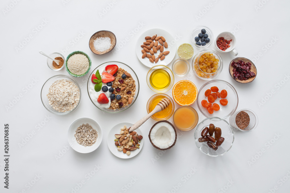 Ingredients for a healthy breakfast - granola, honey, nuts, berries, fruits, top view. Ingredients for a healthy breakfast - granola, honey, nuts, berries, fruits, top view.