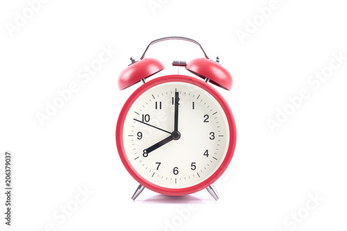 Classic retro red alarm clock isolated on a white background