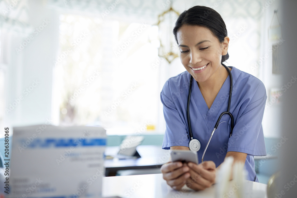 Smiling female doctor using smart phone while working in hospital Smiling female doctor using smart phone while working in hospital