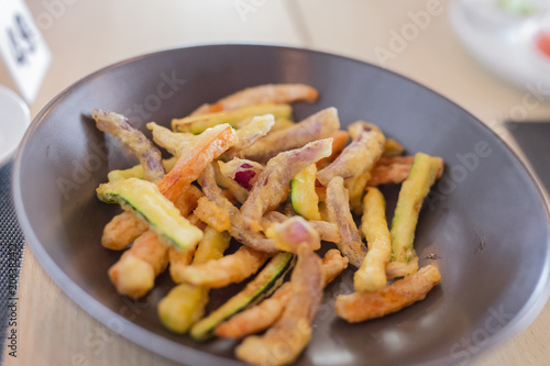 closeup of plate with various fried vegetables