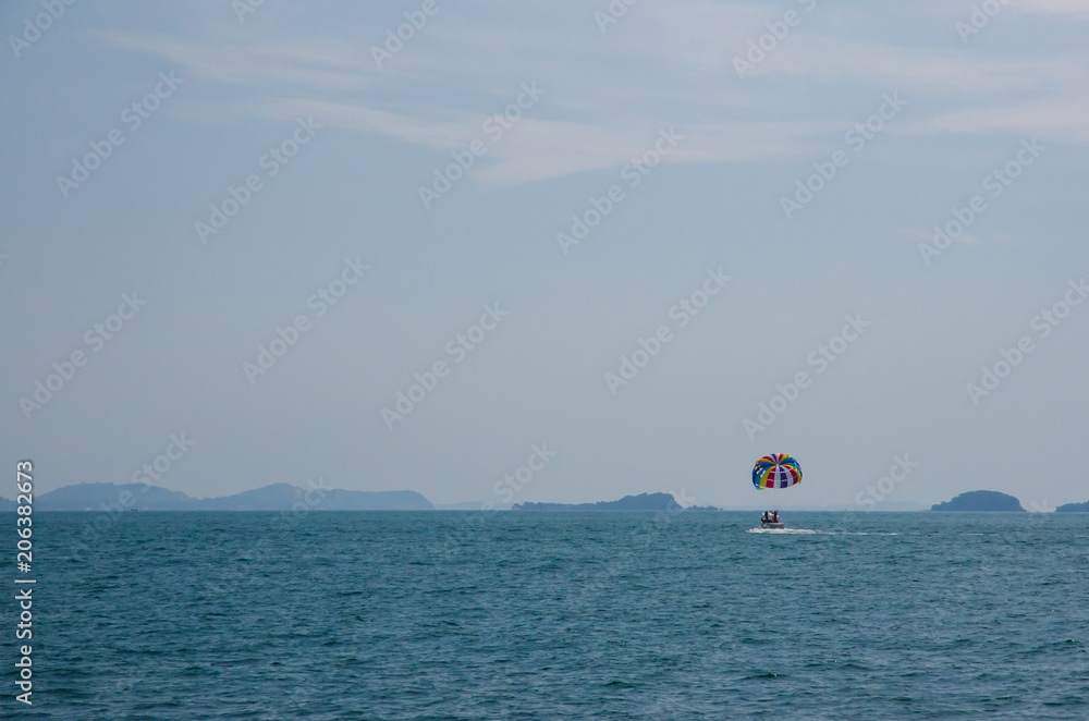 Tourists play colorful parachute sailing Tourists play colorful parachute sailing