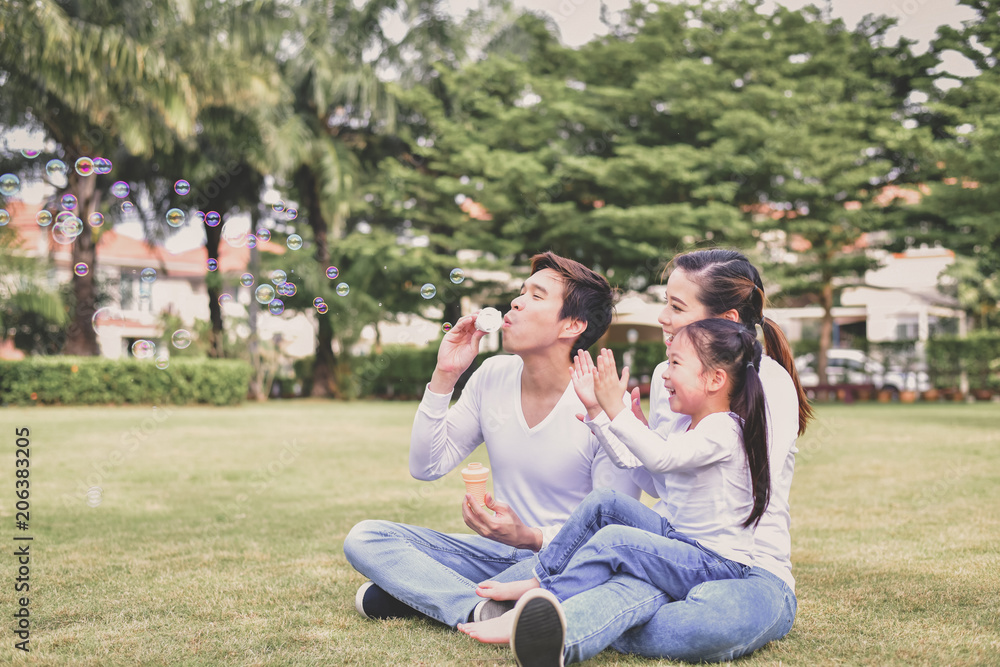 Family Concept. Happy male and female playing with children outside. Family is doing happy activities at Playground. Parents are playing happily. Family Concept. Happy male and female playing with children outside. Family is doing happy activities at Playground. Parents are playing happily.
