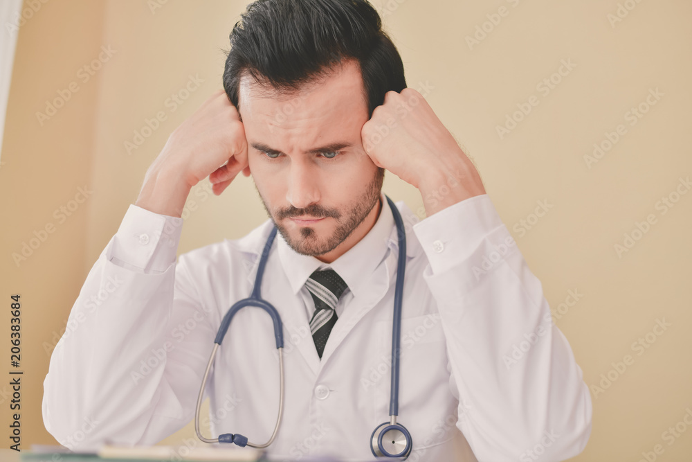 Doctor Concept. Doctors are making serious faces. The doctor is stressed about work. The doctor is feeling a headache at work. The doctor is feeling stressed in treating the patient. Doctor Concept. Doctors are making serious faces. The doctor is stressed about work. The doctor is feeling a headache at work. The doctor is feeling stressed in treating the patient.