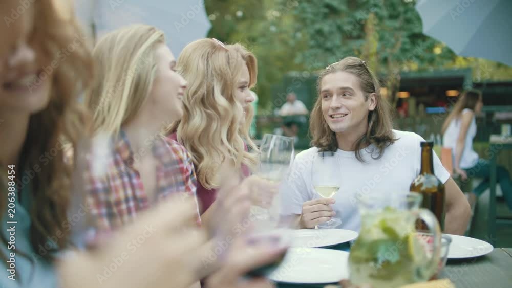 Friends With Drinks At Dinner Party Outdoors. Friends With Drinks At Dinner Party Outdoors.