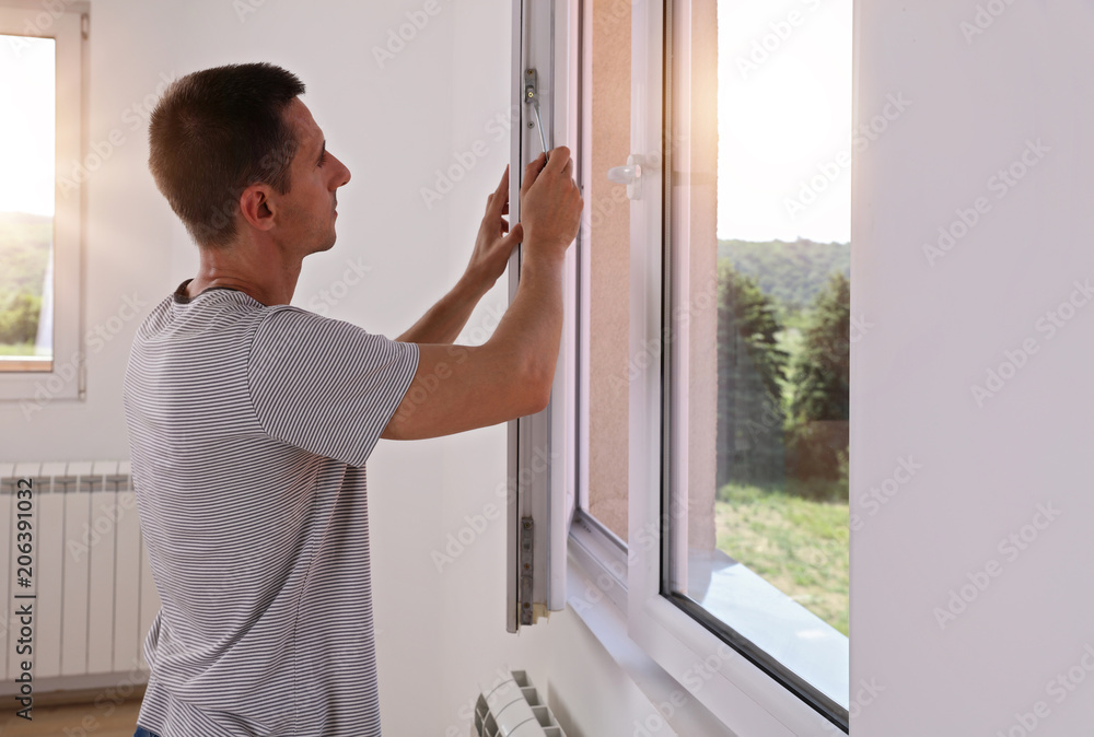 Man Installing New Windows In House Man Installing New Windows In House