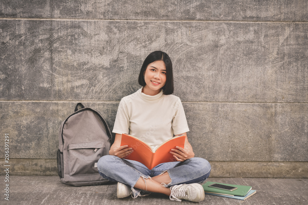 Education Concepts. Asian women reading books in the University. Beautiful women are relaxing in the University. Beautiful women are happy to read. Asian girls love to study. Education of Asian Women.