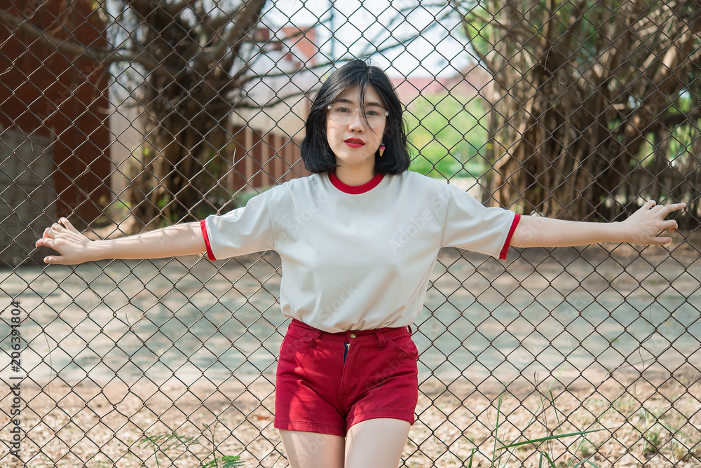 Portrait of beautiful asian chic girl pose for take a picture on the fence,Lifestyle of teen thailand people,Modern woman happy concept Portrait of beautiful asian chic girl pose for take a picture on the fence,Lifestyle of teen thailand people,Modern woman happy concept