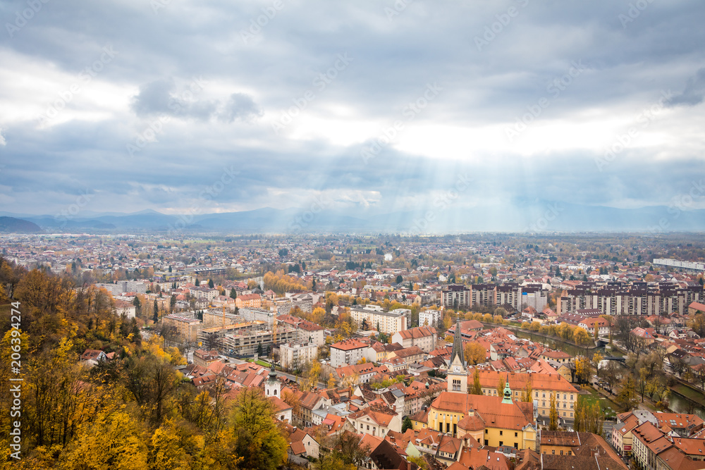 View of Ljubljana city from above during overcast day with sun rays, Ljubljana, Slovenia