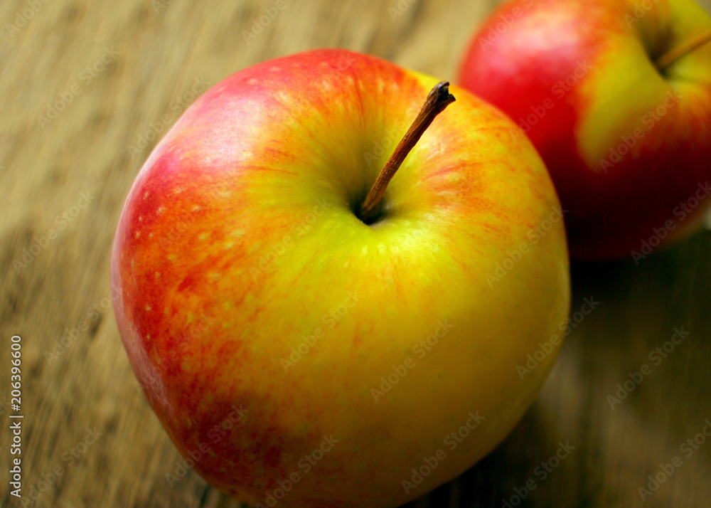 two juicy ripe apples on the background of an old wooden table close-up two juicy ripe apples on the background of an old wooden table close-up
