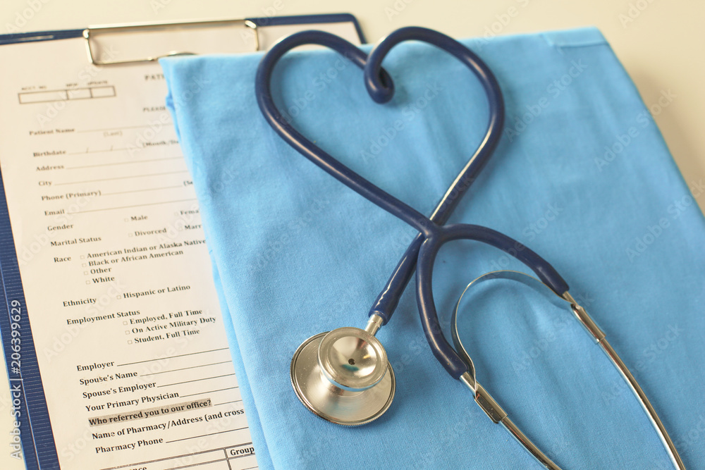 A stethoscope shaping a heart on a medical uniform, closeup, selective focus A stethoscope shaping a heart on a medical uniform, closeup, selective focus