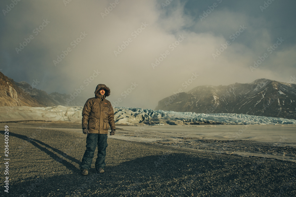 Young man standing with Vatnajokull Glacier as background