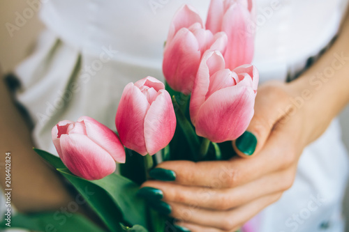 Close-up woman takes flowers as a gift