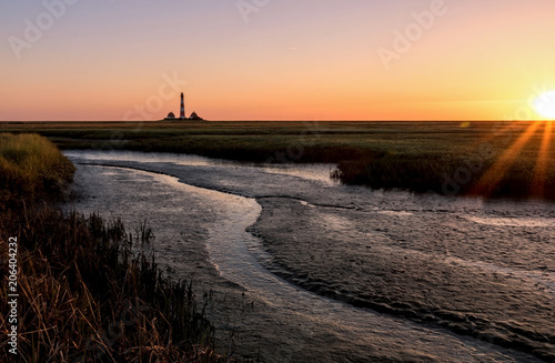 Westerhever Leuchtturm mit Watt / Lighthouse in Germany at sunset with salt flats