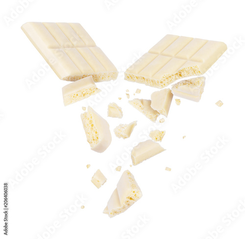 Billede på lærred White porous chocolate broken into pieces in the air