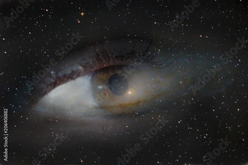 Fototapeta Naklejka Na Ścianę i Meble -  A photograph with a double exposure, the eye looking from the depths of the galaxy into the infinite space of the cosmos. People dream of future interstellar flights
