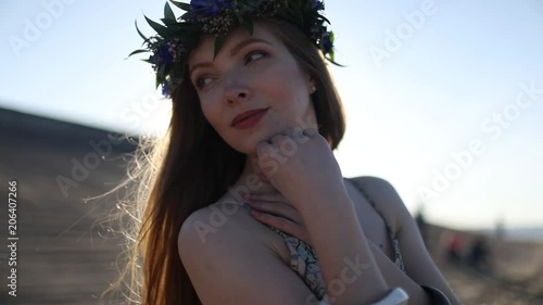 Young beautiful woman walking on the beach photo