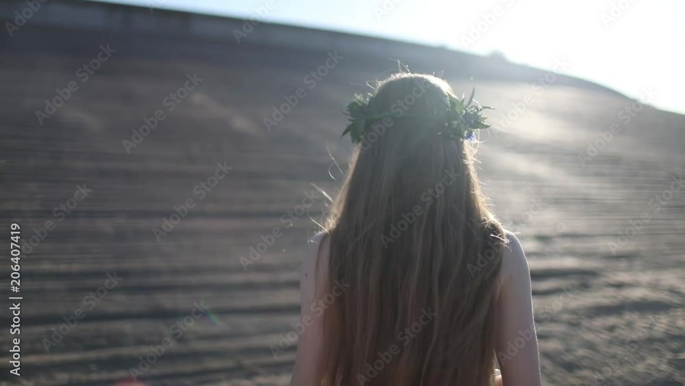 Young beautiful woman walking on the beach Young beautiful woman walking on the beach
