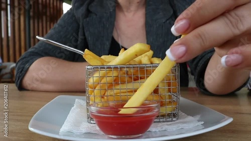 Close up  of eating Potato Fries with Tomato Ketchup at the Table Street Food Cafe