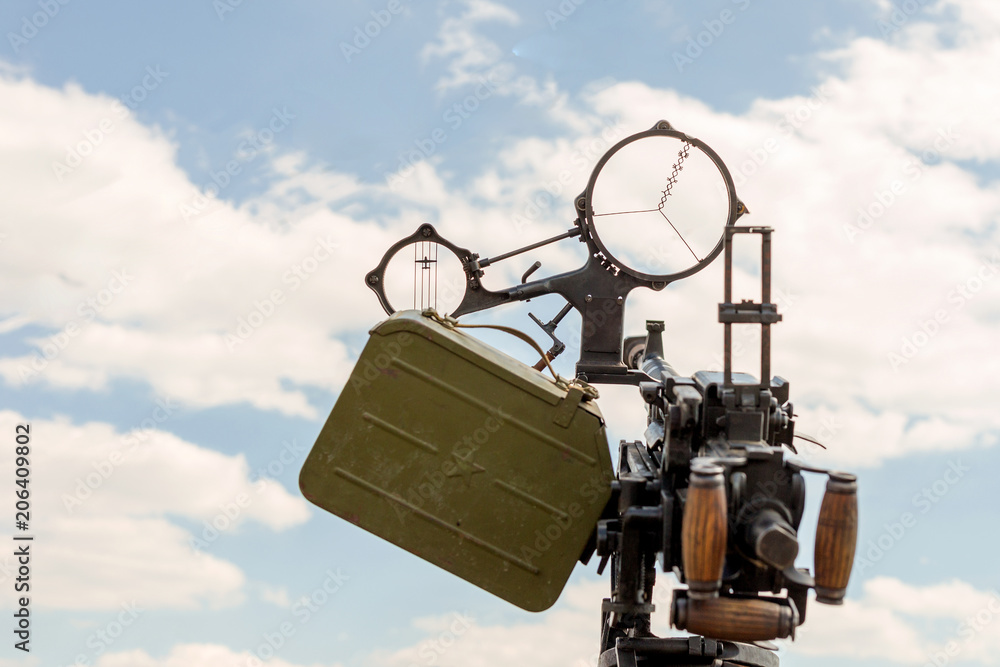 Old ww2 anti-aircraft machine gun. Close-up front view with cannon aim against clear blue sky Old ww2 anti-aircraft machine gun. Close-up front view with cannon aim against clear blue sky