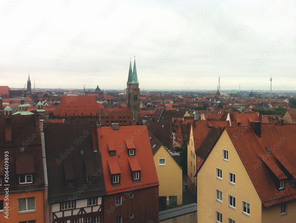 View from the height of the European city. Germany view of the red roofs of buildings of old Europe. Photo in cloudy weather