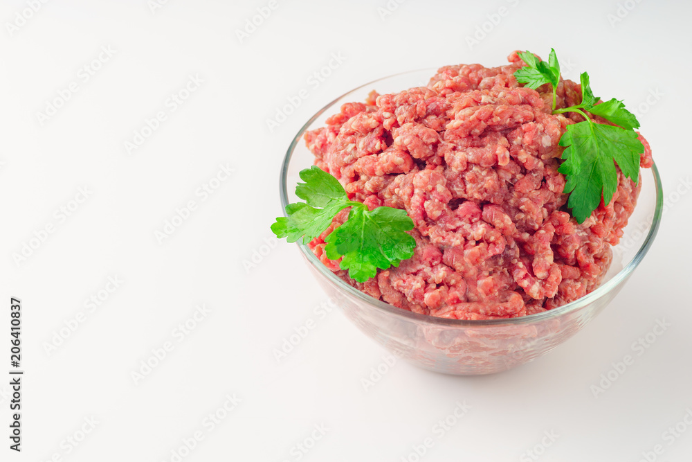 Raw minced meat in a plate on white background Raw minced meat in a plate on white background