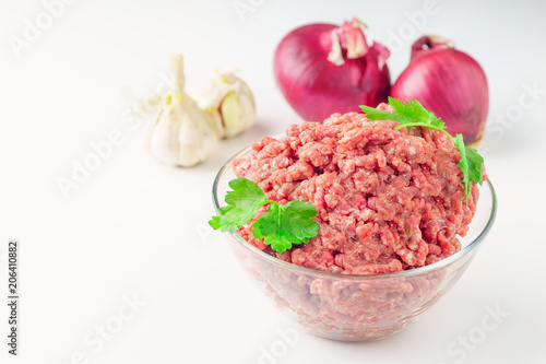 Raw minced pork in a plate onwhite close-up