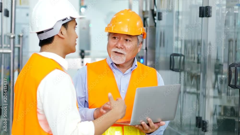 Engineer talking for project on the factory floor. architecture using laptop for working at factory. People working concept. Engineer talking for project on the factory floor. architecture using laptop for working at factory. People working concept.