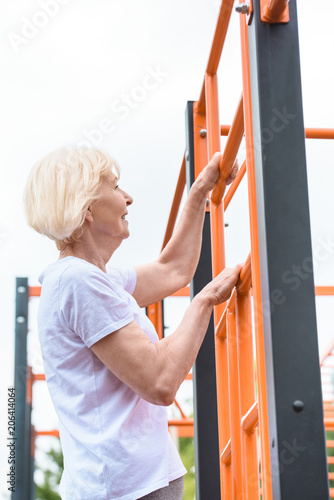 senior sportswoman working out on sports ground