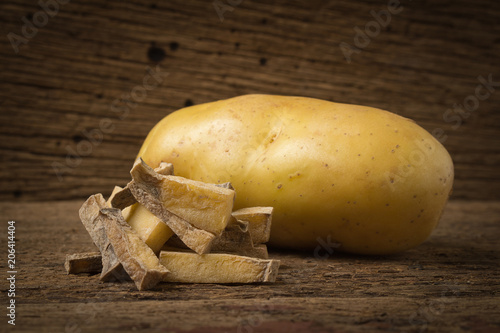 piece potato dry . peel on old wood. rotten photo