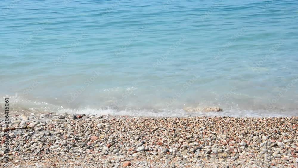 Grainy sand tropical beach, blue ocean sea wave washes the shore. Montenegro beach Grainy sand tropical beach, blue ocean sea wave washes the shore. Montenegro beach