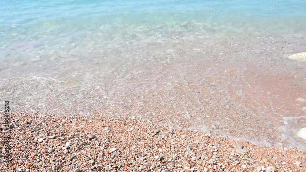 Grainy sand tropical beach, blue ocean sea wave washes the shore. Montenegro beach Grainy sand tropical beach, blue ocean sea wave washes the shore. Montenegro beach