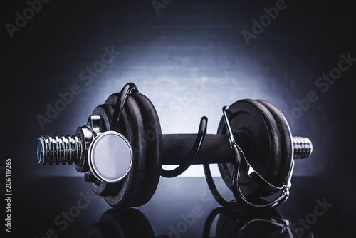 close-up view of stethoscope and dumbbell, healthy lifestyle concept