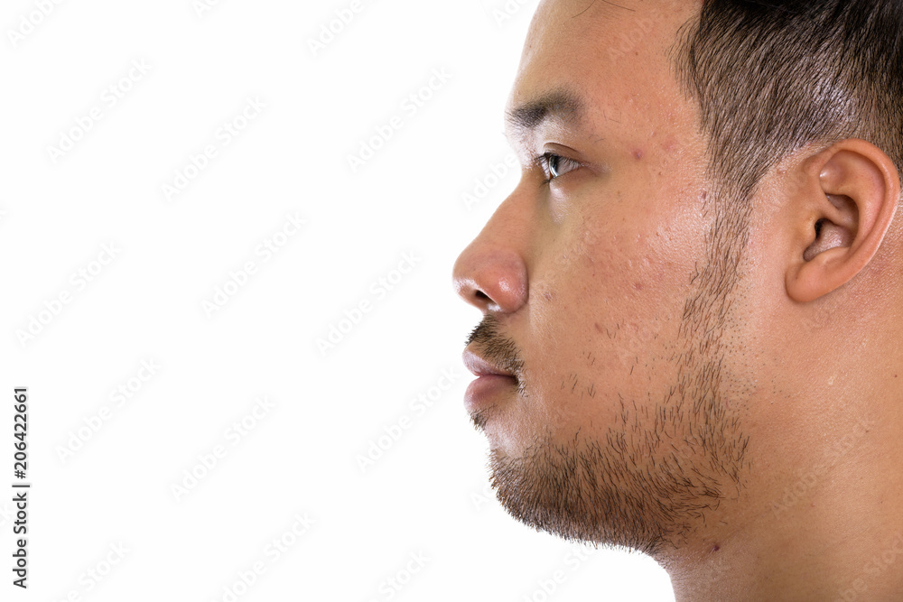 Close up profile view of young Asian man 