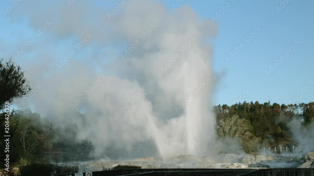Powerful geyser seen from wooden viewing platform in Rotorua, New Zealand Powerful geyser seen from wooden viewing platform in Rotorua, New Zealand