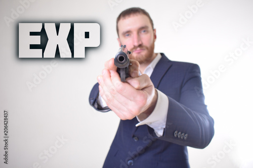 The businessman holds a gun in his hand and shows the inscription:EXP