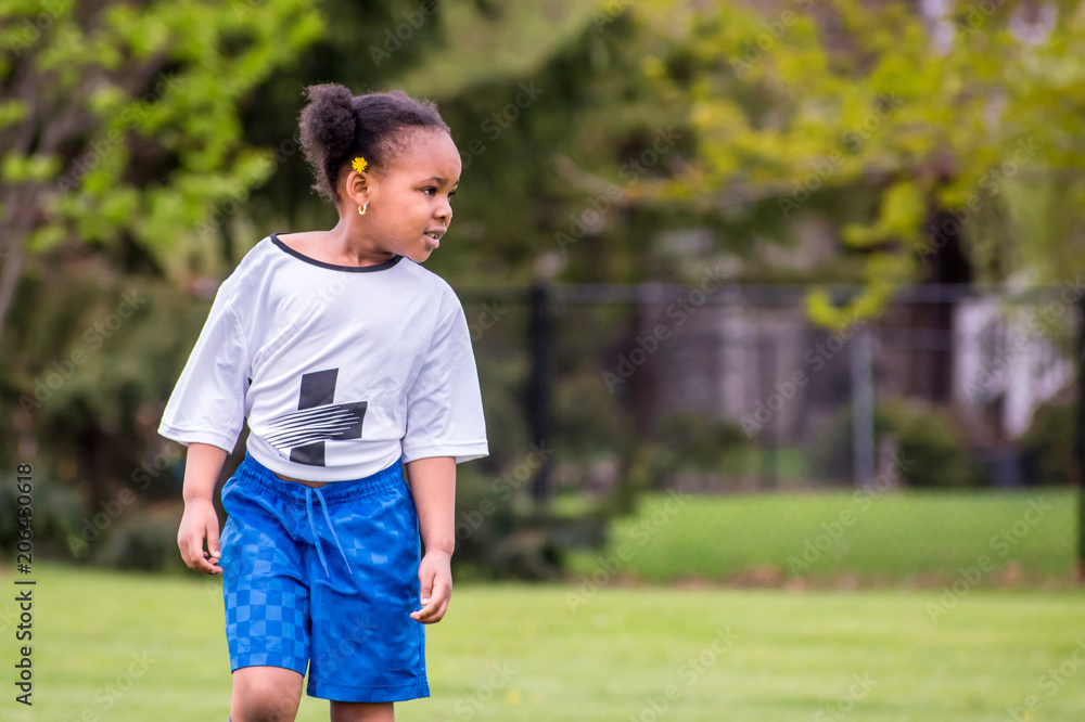 A young girl is learning how to play soccer A young girl is learning how to play soccer