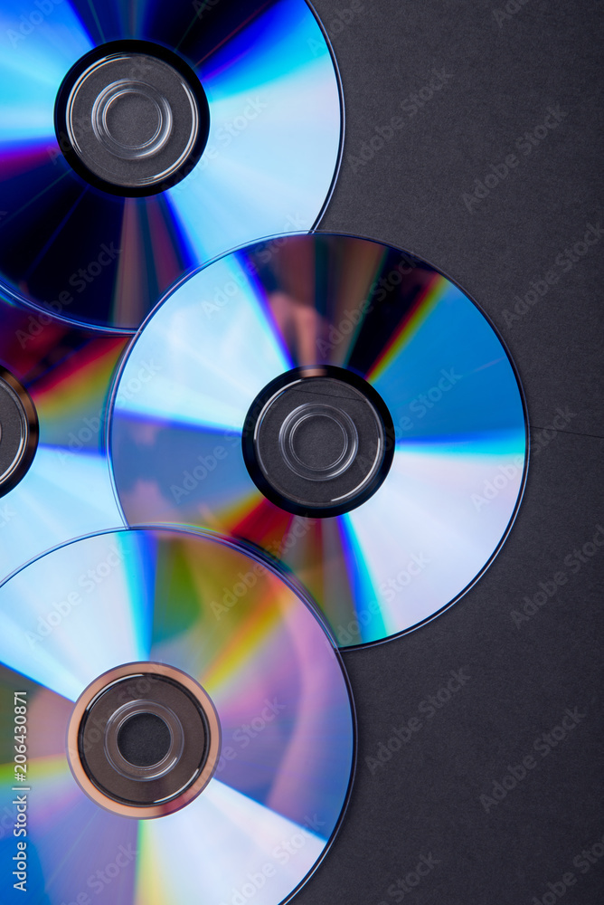 Many musical compact discs with a rainbow spectrum of colors as a bright background Many musical compact discs with a rainbow spectrum of colors as a bright background