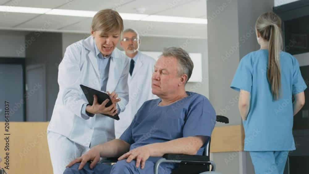 In the Hospital Female Doctor Shows Tablet Computer to Elderly Patient, Explaining his Condition. Modern Hospital with Best Possible Care. Shot on RED EPIC-W 8K Helium Cinema Camera. In the Hospital Female Doctor Shows Tablet Computer to Elderly Patient, Explaining his Condition. Modern Hospital with Best Possible Care. Shot on RED EPIC-W 8K Helium Cinema Camera.