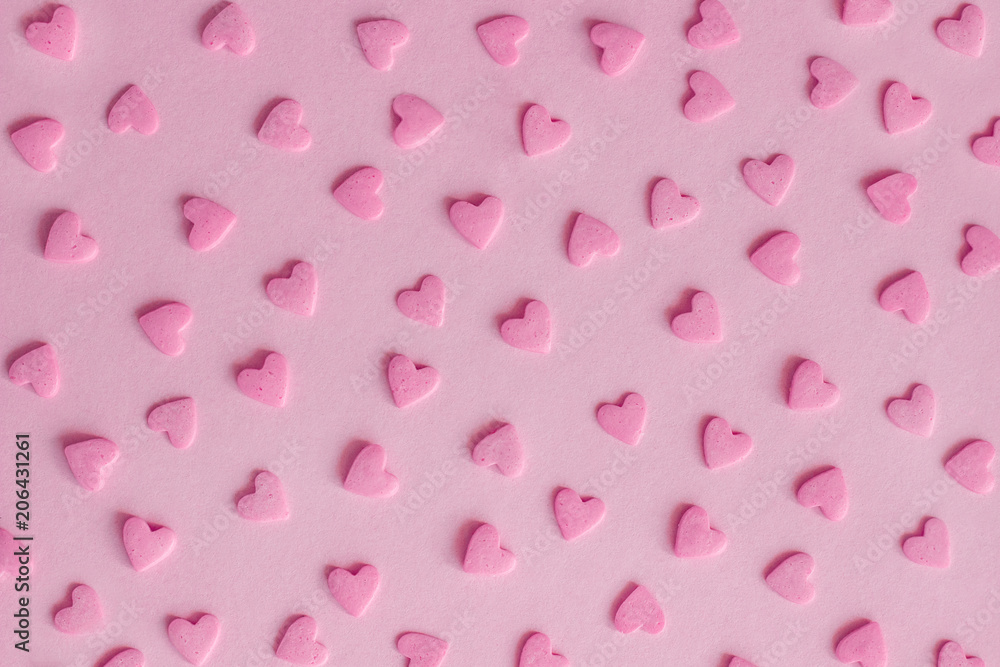 Pattern. Pink confectionery hearts on pink background, texture