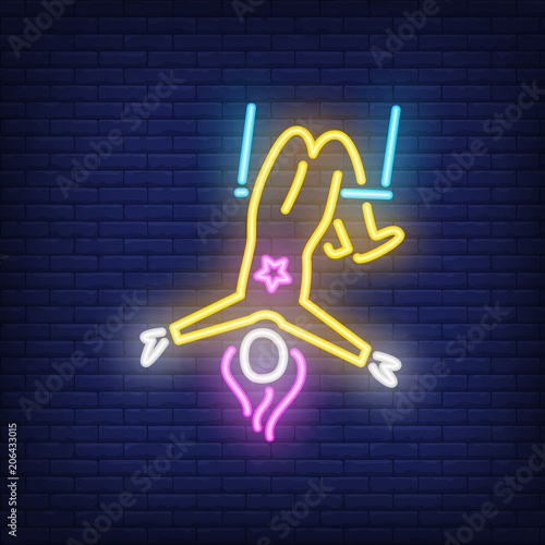Aerial acrobat neon sign. Female circus gymnast on trapeze on dark brick wall background. Night bright advertisement. Vector illustration in neon style for performance poster or festival