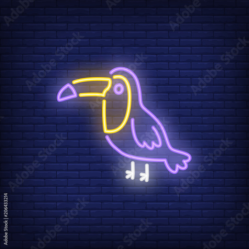 Toucan neon sign. Tropical bird on dark brick wall background. Night bright advertisement. Vector illustration in neon style for pet shop or zoo