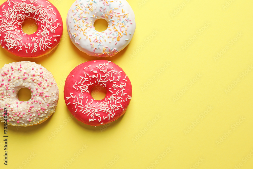 Delicious glazed doughnuts on color background, top view Delicious glazed doughnuts on color background, top view