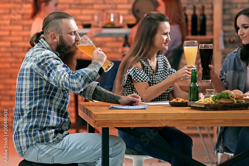 Friends with beer and snacks in sport bar