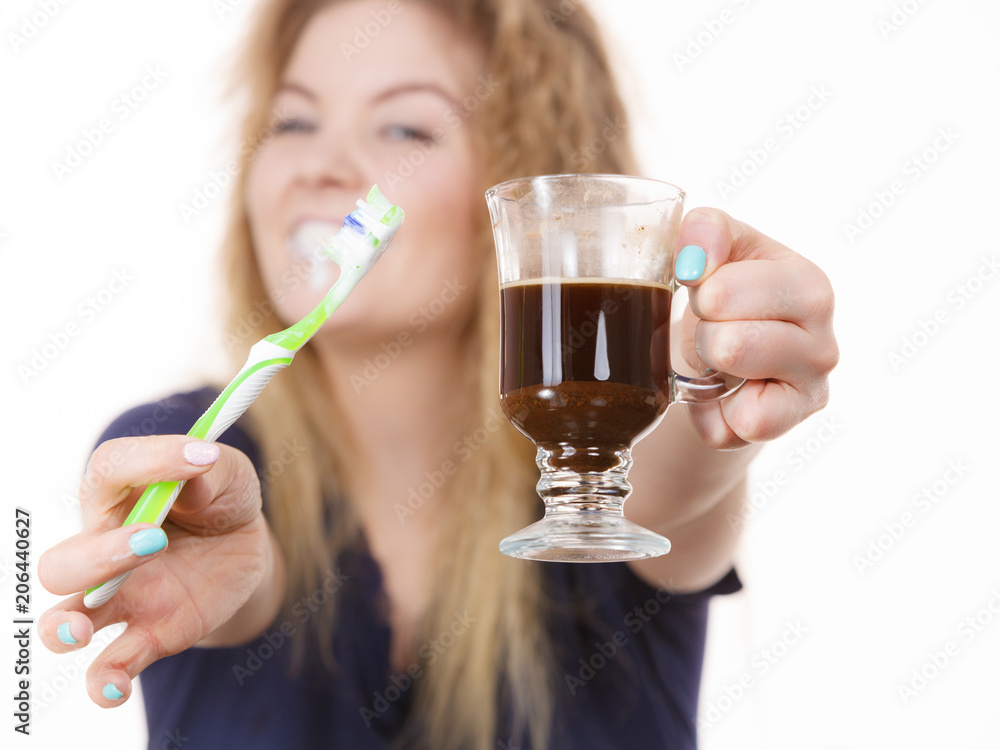 Happy woman holding toothbrush and coffee Happy woman holding toothbrush and coffee