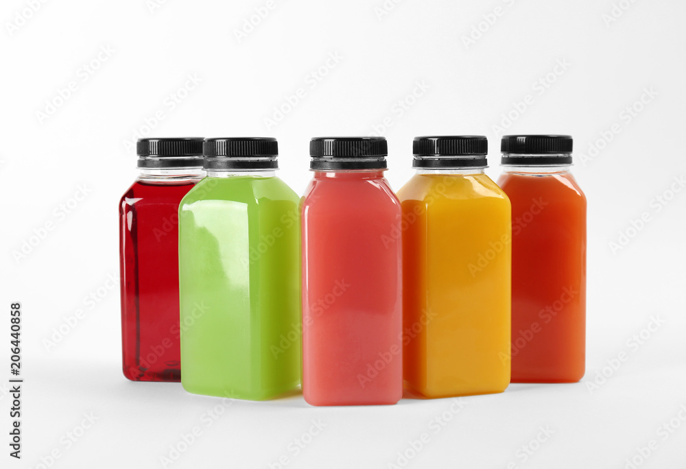 Bottles with delicious colorful juices on white background Bottles with delicious colorful juices on white background
