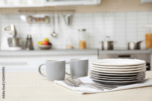 Photos Tableware and blurred view of kitchen interior on background