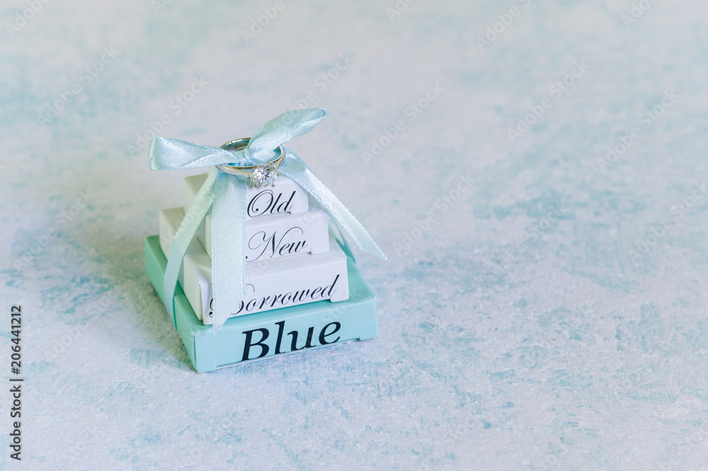 © Regina - Wedding accessories. Elegant jewelry ring with gift boxes. Sky blue background with copy space for text. Blank stationary template / invitation mockup. Soft focus. © Regina - Wedding accessories. Elegant jewelry ring with gift boxes. Sky blue background with copy space for text. Blank stationary template / invitation mockup. Soft focus.