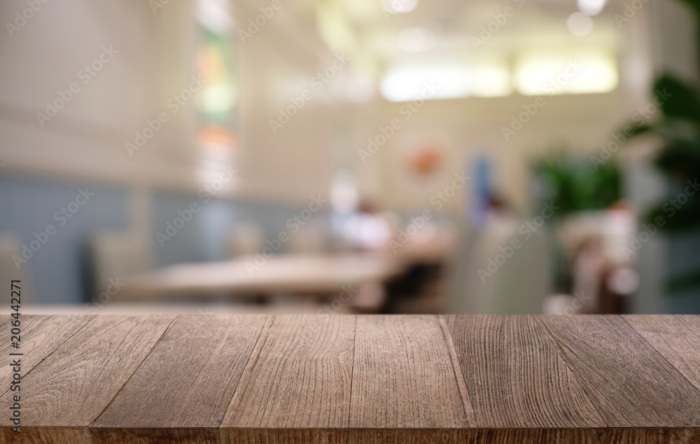 Empty dark wooden table in front of abstract blurred bokeh background of restaurant . can be used for display or montage your products.Mock up for space. Empty dark wooden table in front of abstract blurred bokeh background of restaurant . can be used for display or montage your products.Mock up for space.
